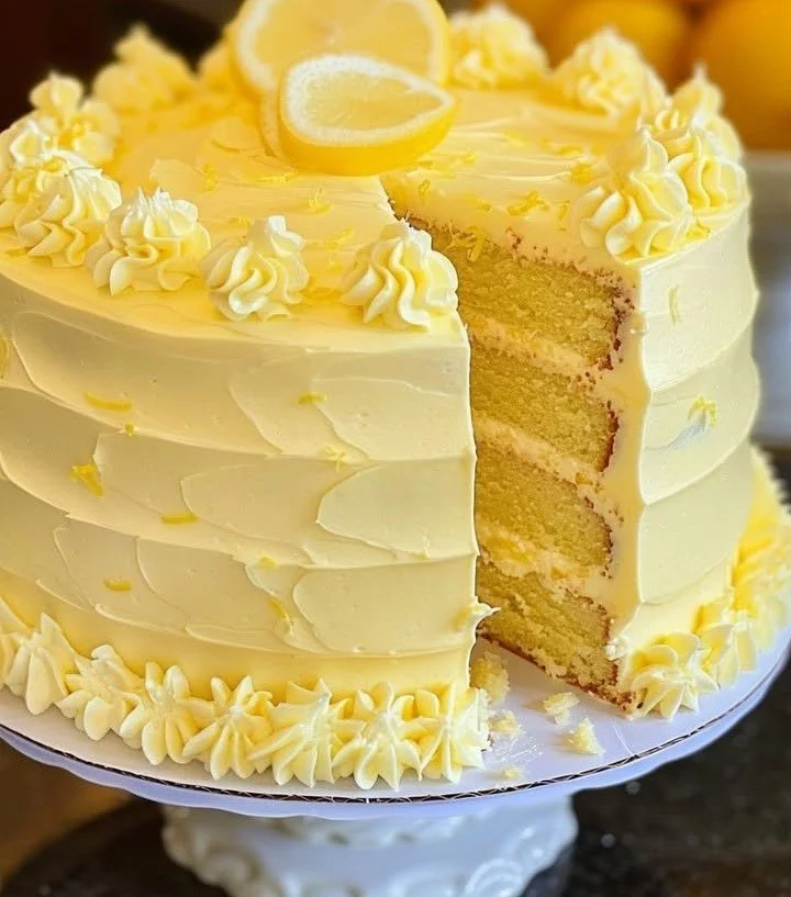 Slice of Velvet Lemon Cream Layer Cake with lemon zest and creamy frosting